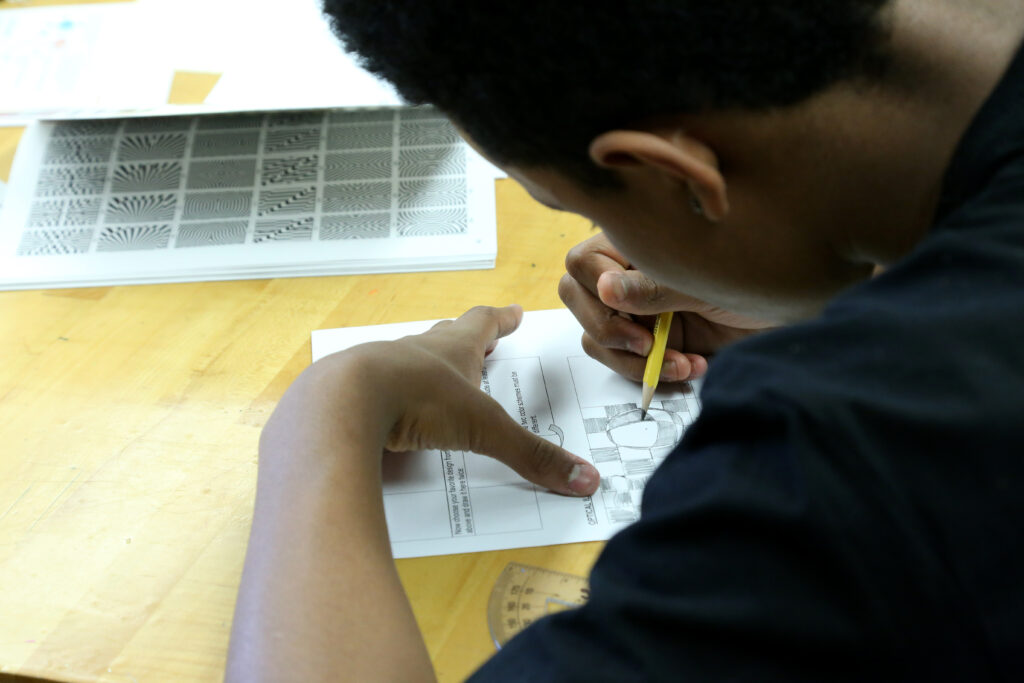 student working on optical illusion drawing