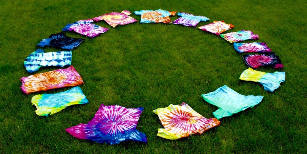 tie-dye shirts laid out in a circle