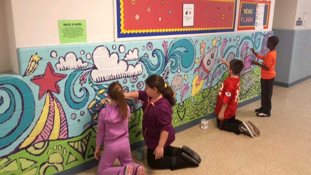 students working together on mural