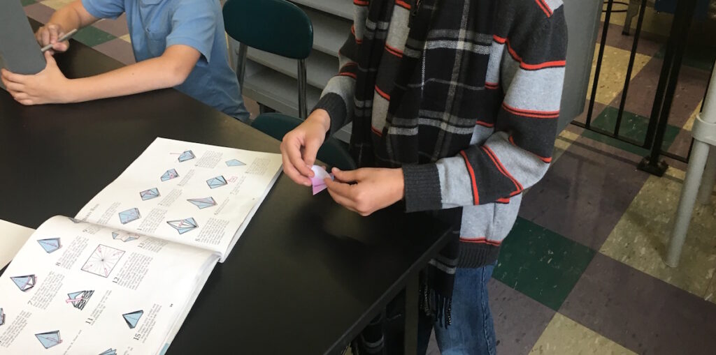 student doing origami