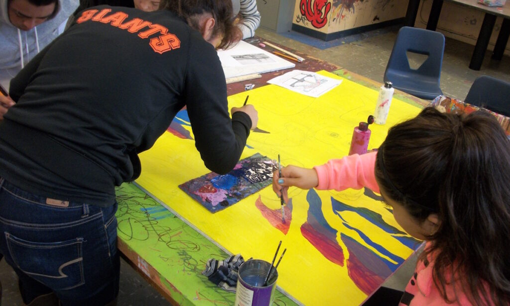students collaborating on painting