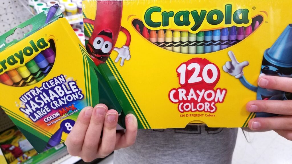 kid holding crayons