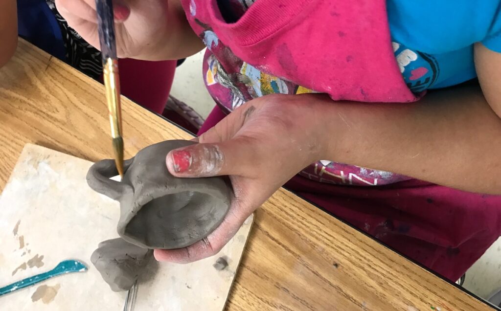 student working with clay
