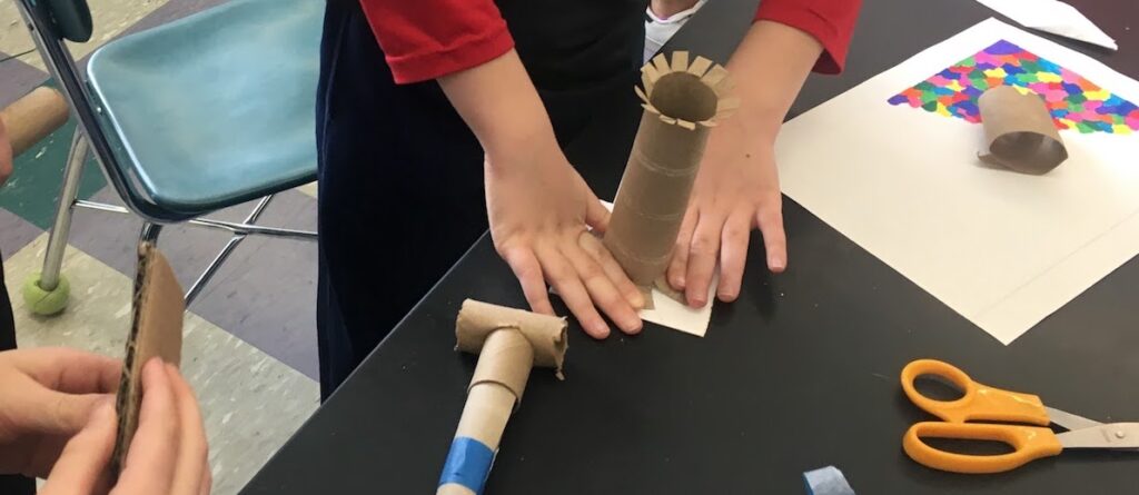 student working with paper towel tube