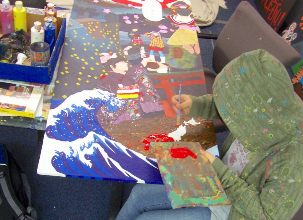 student working on large, detailed painting