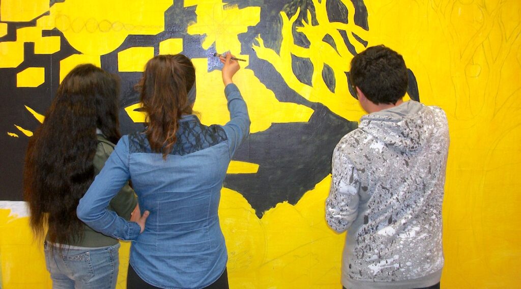 students working on mural