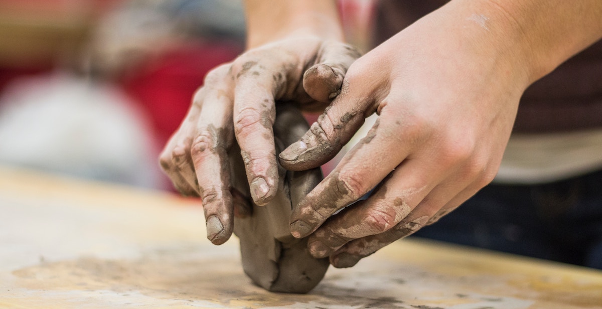 hands wedging clay