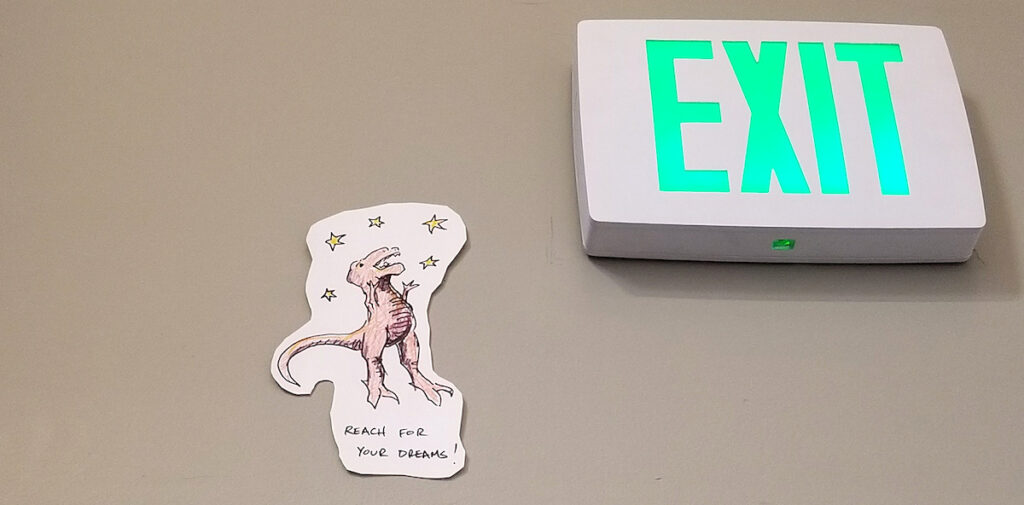 positive message from student hung near exit sign