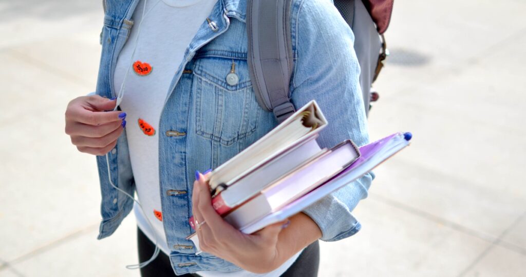 teen walking with books