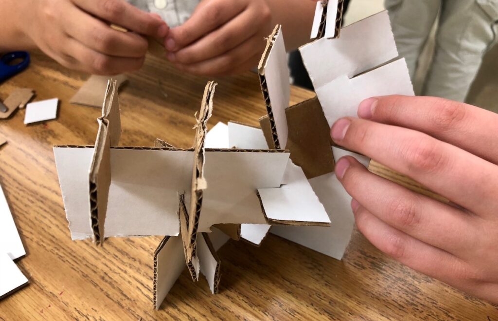 students building with cardboard