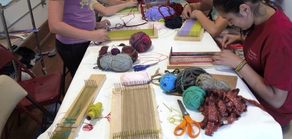 students working on weaving