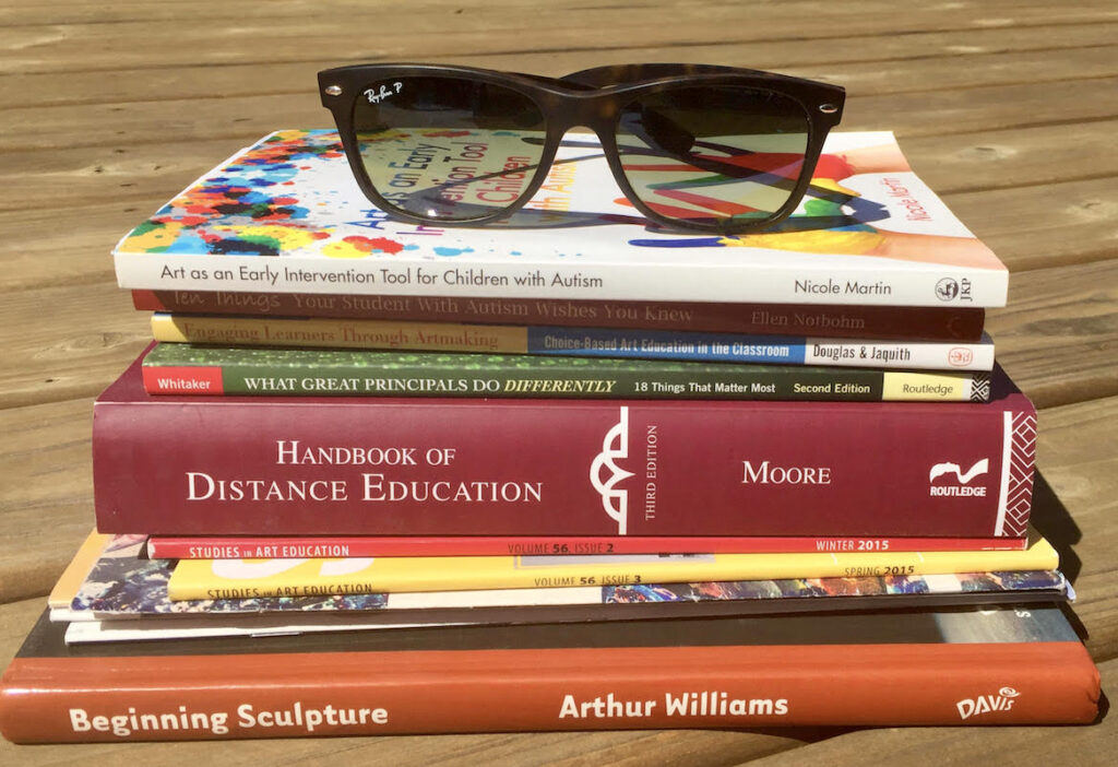 stack of PD books with sunglasses on top