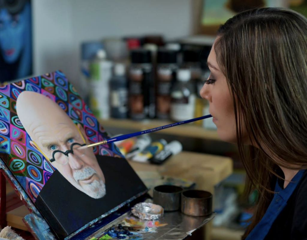 Pare working on a painting of Chuck Close