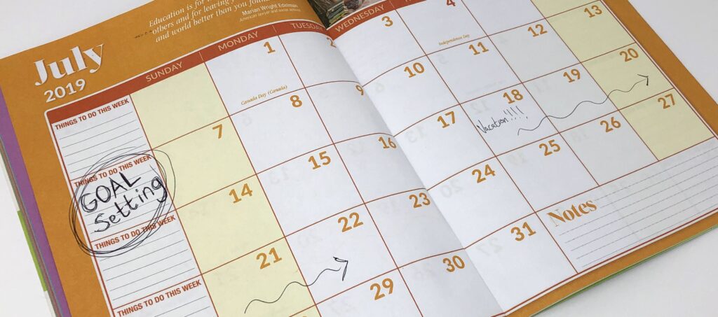 calendar on the month of July with Goal Setting written in the second week