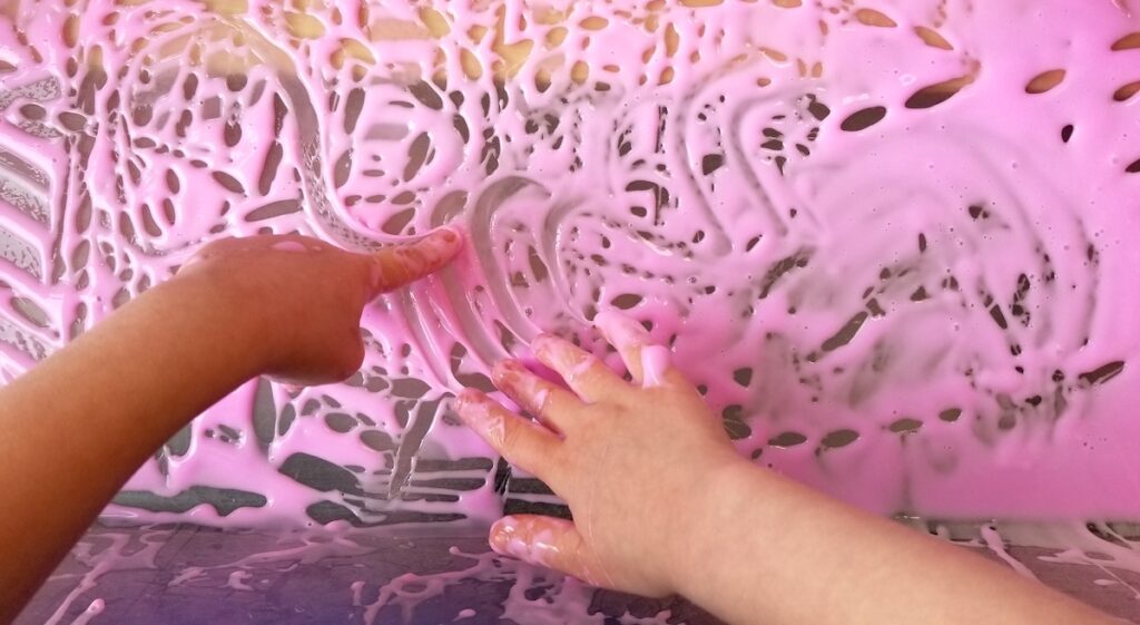 Image of student hands in fingerpaint