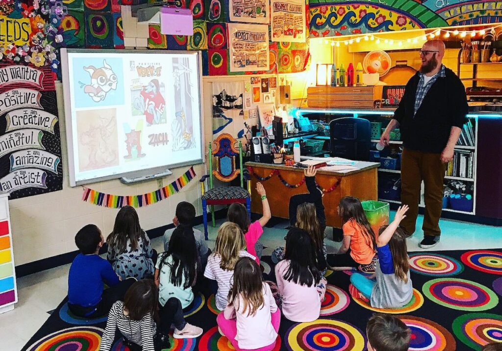 Picture of artist speaking to elementary classroom