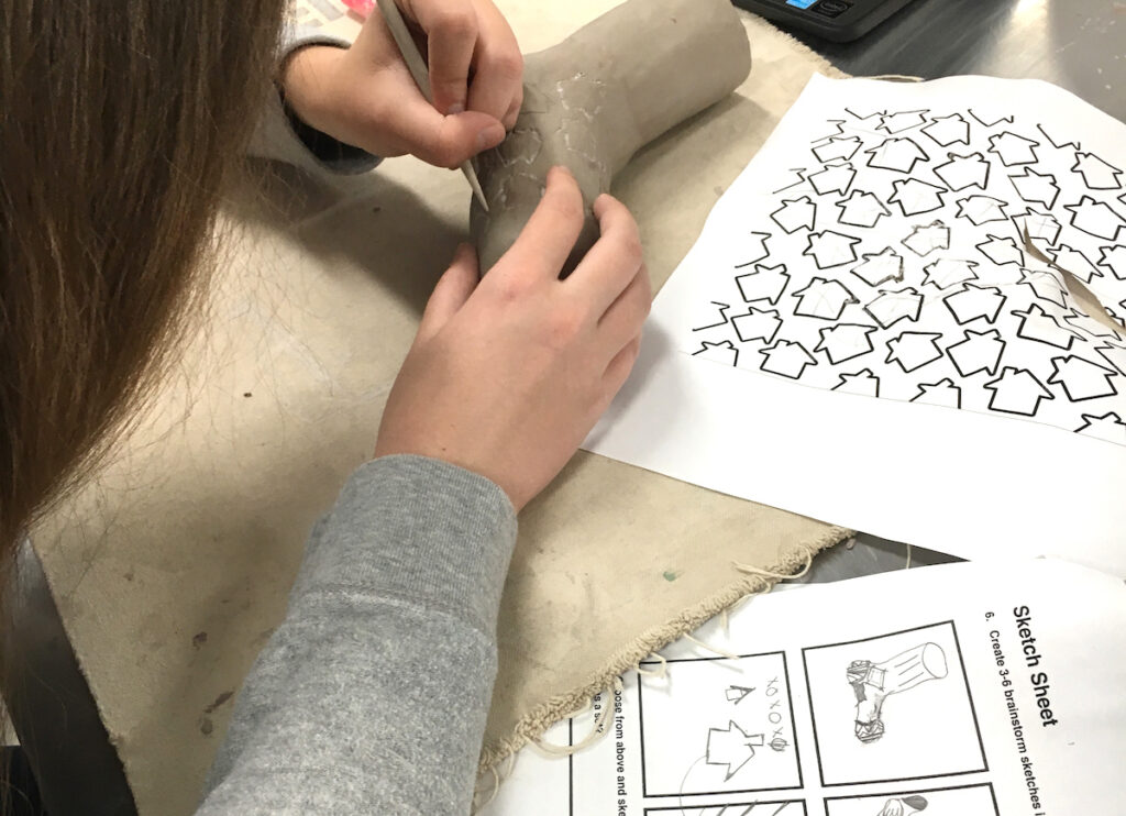 Student working on clay artwork