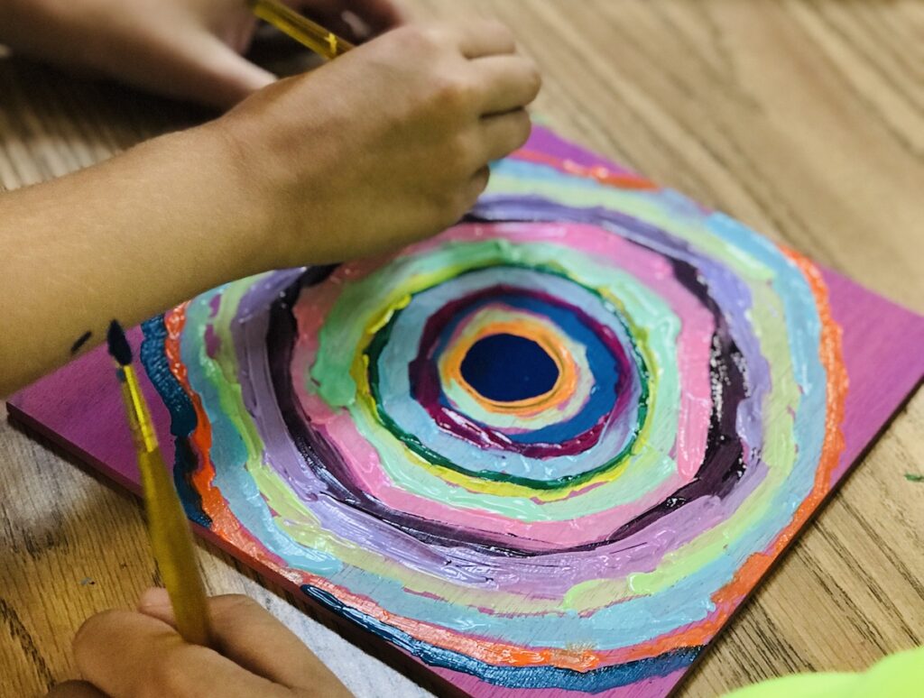 students painting artwork in the style of "the dot"