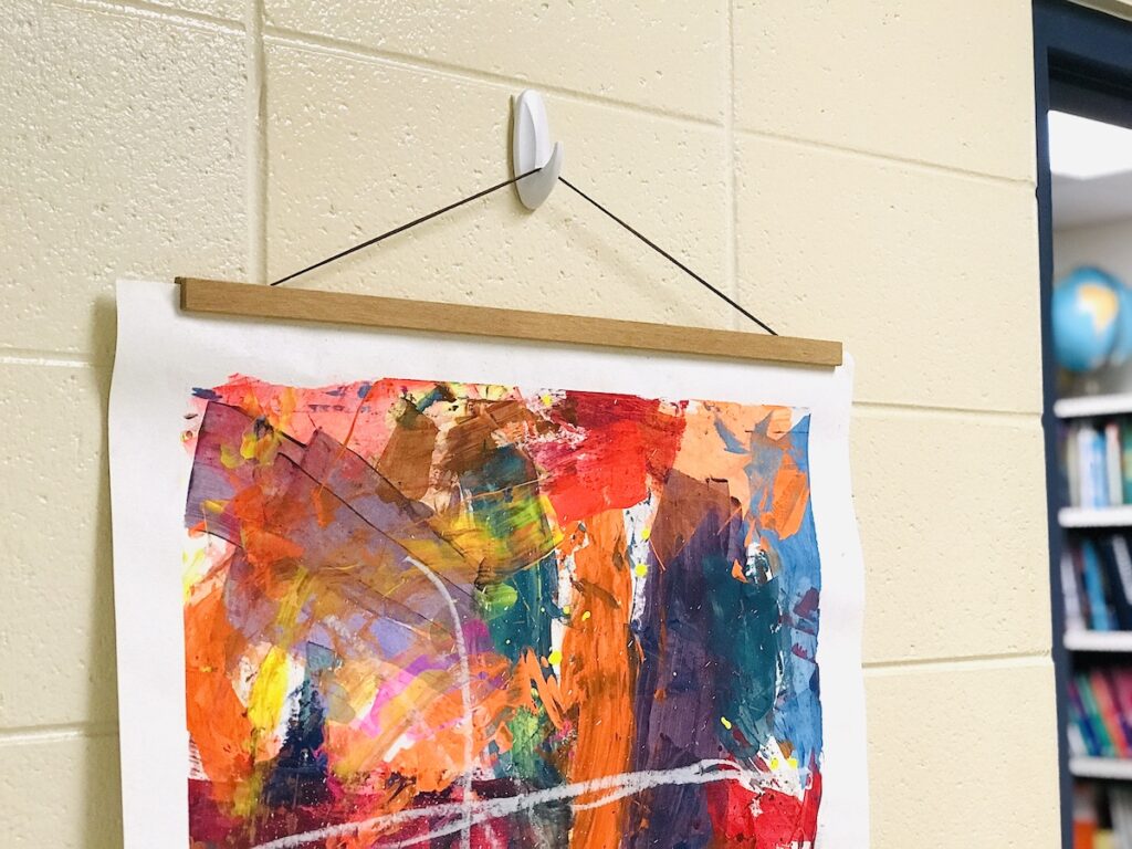 Hanging artwork on cinderblock in detail