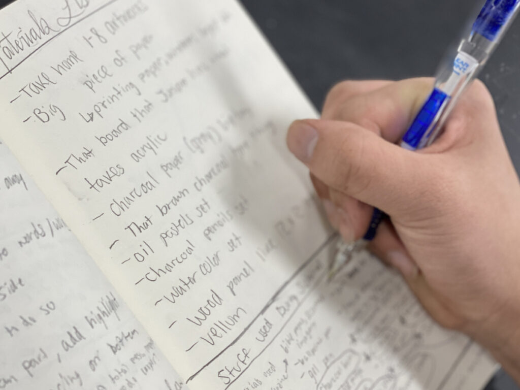 a hand writing a list