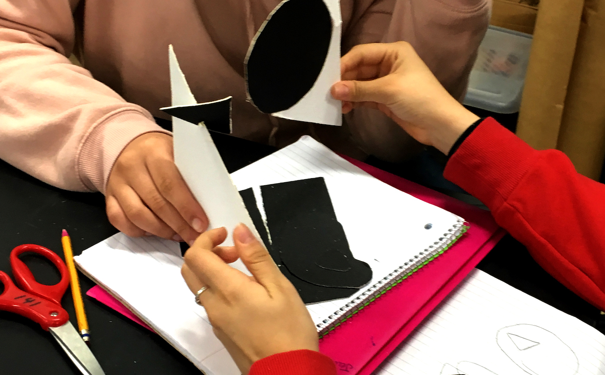 Students creating a paper sculpture