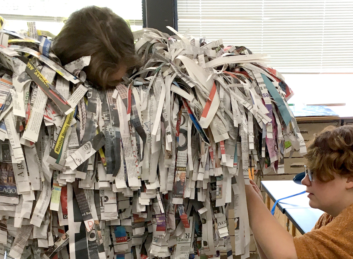 Students creating a paper costume