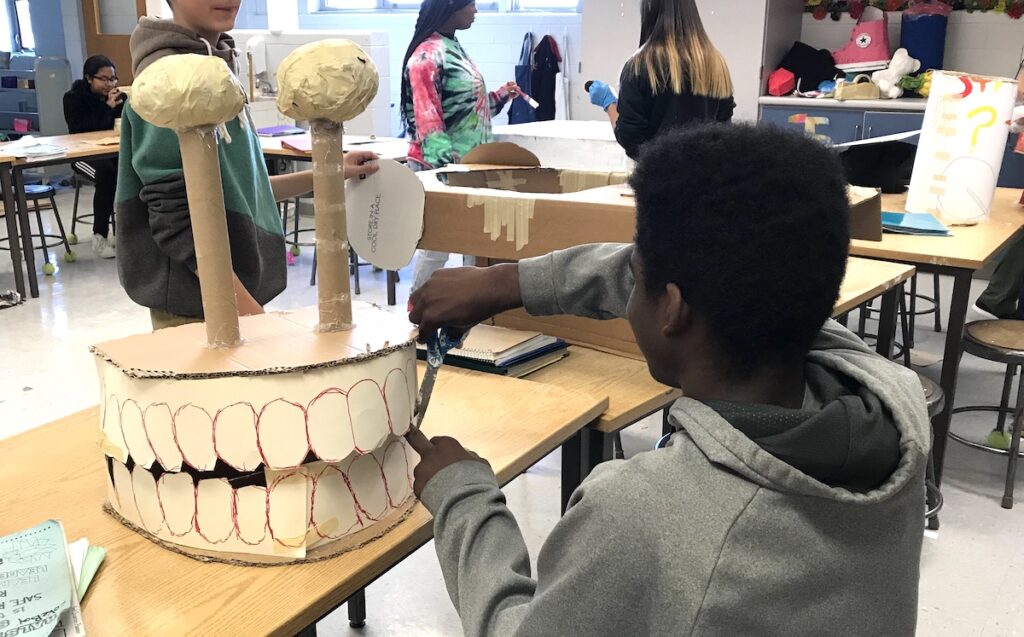 student working with toilet paper rolls