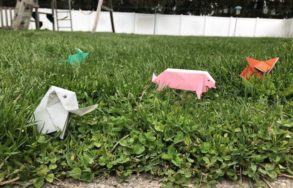image of paper animals in grass