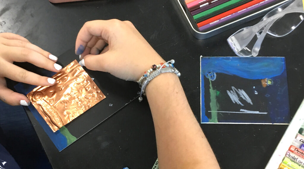 student working on metals
