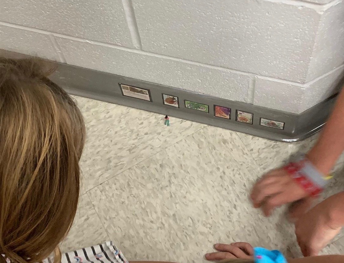 Students looking at tiny art display