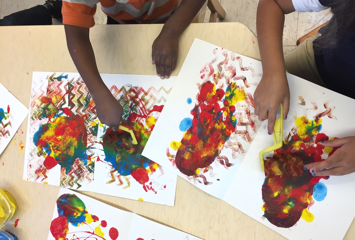 students making artwork with the primary colors red, yellow, and blue