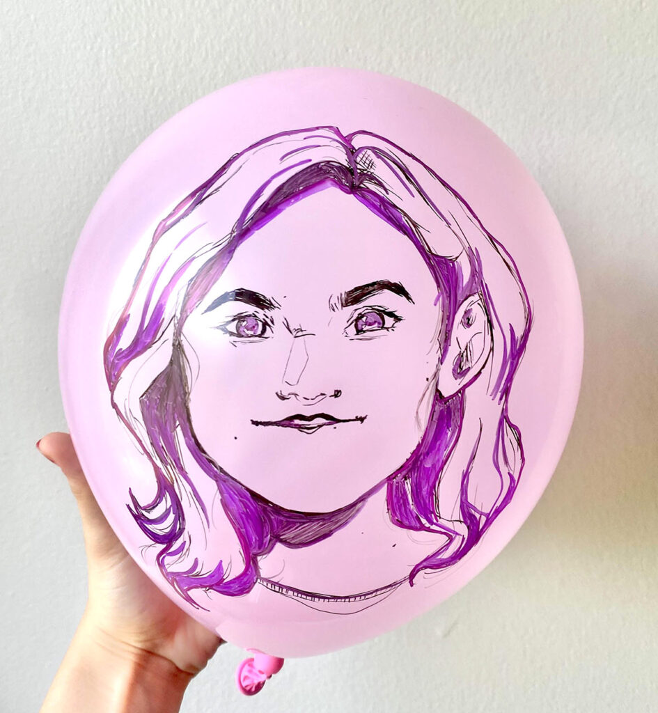self portrait drawn on purple balloon with purple marker