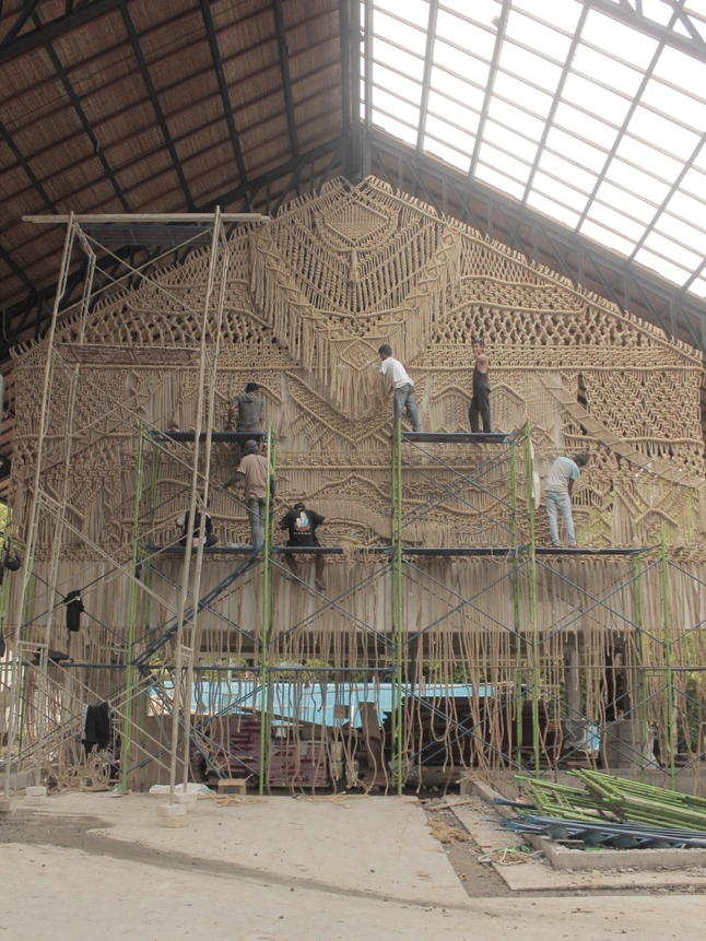 artisans installing fiber mural