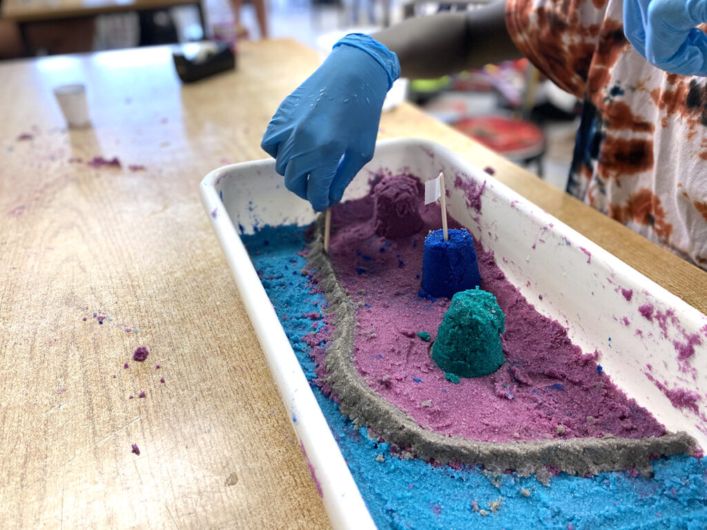 student building with colored sand