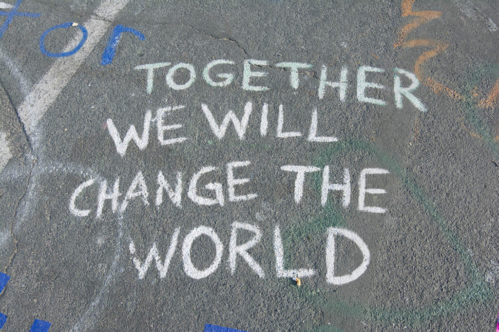 together we will change the world chalk on pavement