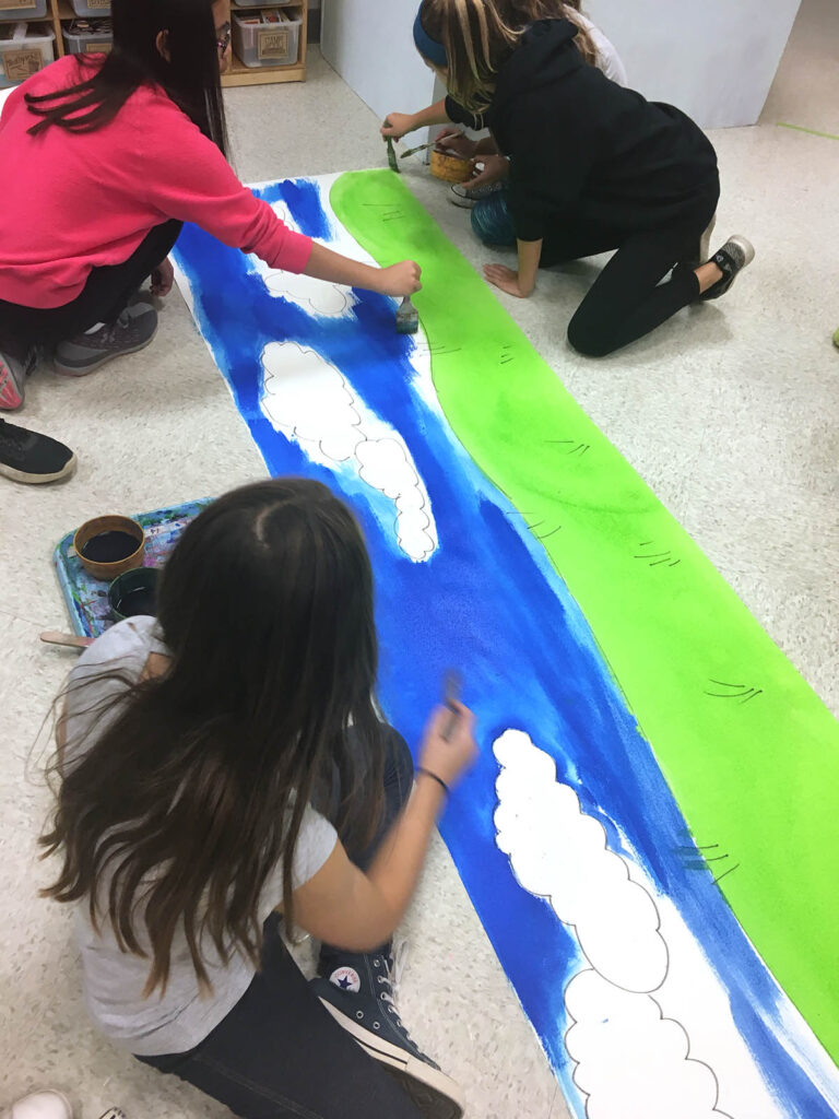 students working on a mural