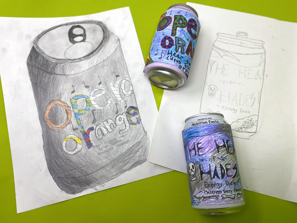 two soda cans and drawing