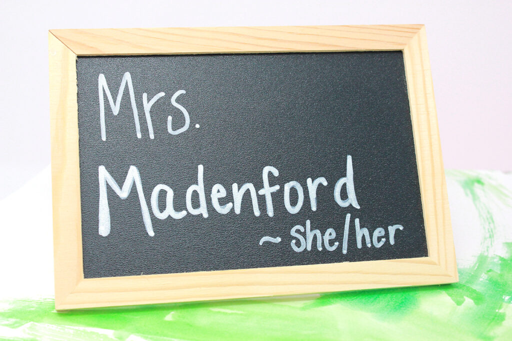 teacher name with pronouns on chalkboard