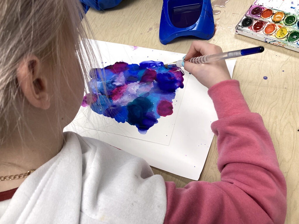 student painting with watercolor