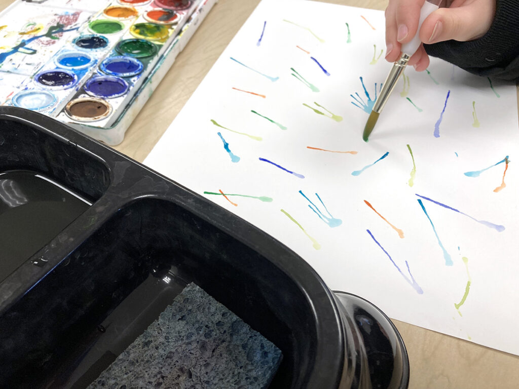 student painting with watercolor