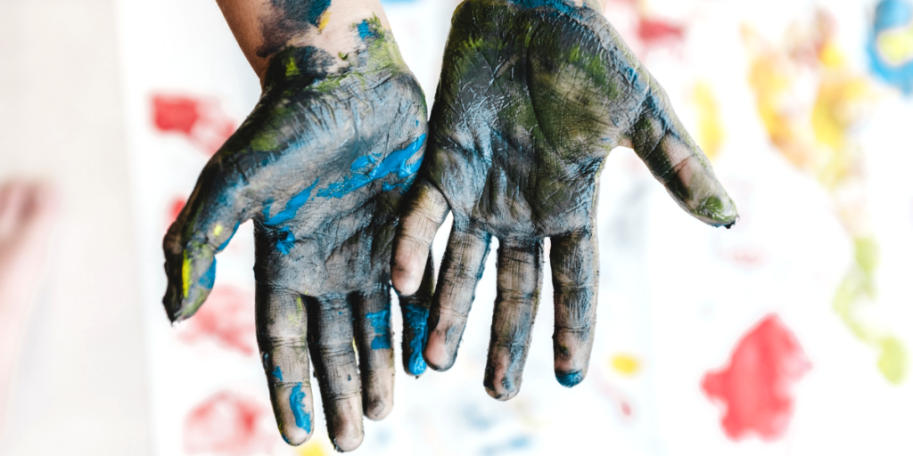 hands with blue paint