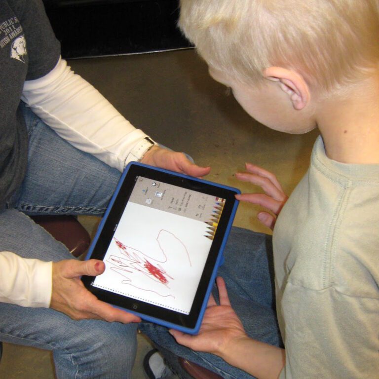 child working on iPad