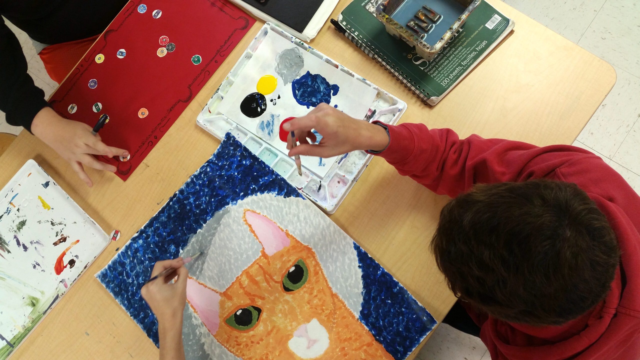 student working on cat painting