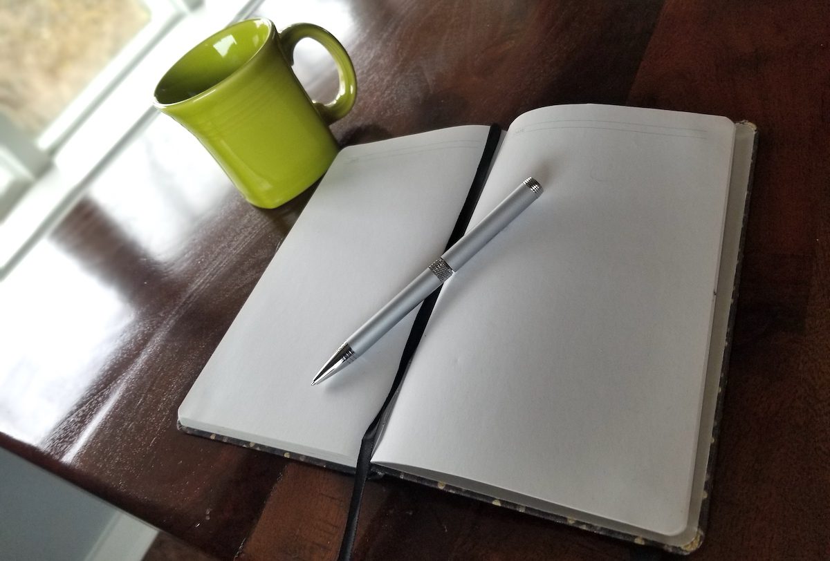 Notebook, pen and coffee mug