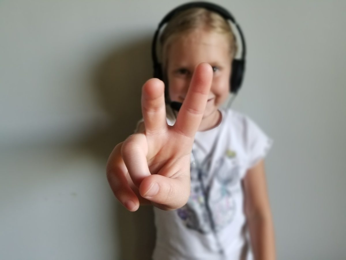 Kid holding up 2 fingers