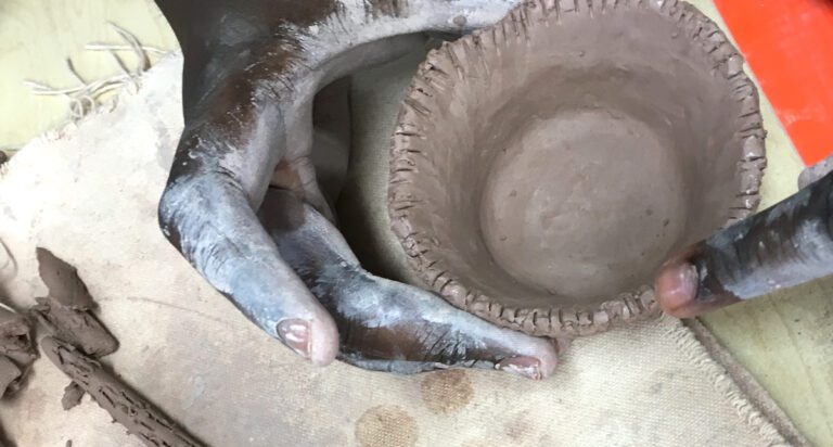 Hands making bowl out of clay