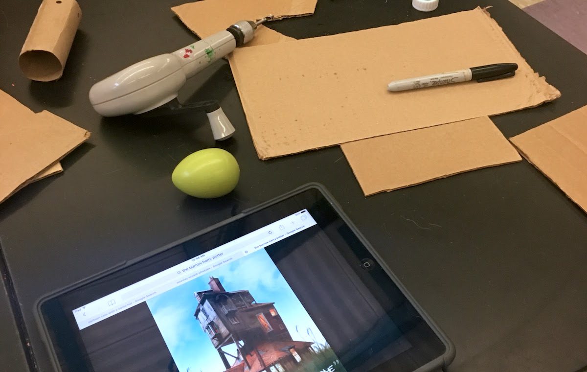 cardboard pieces with iPad showing a house