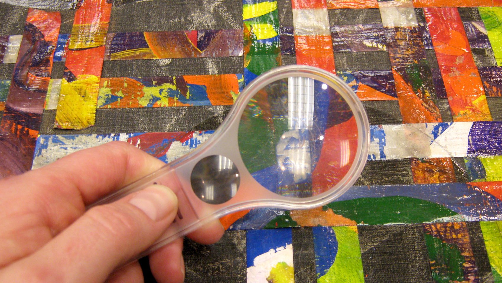 magnifying glass over colored paper