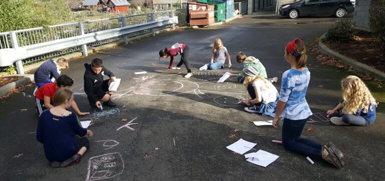 students working with chalk outside