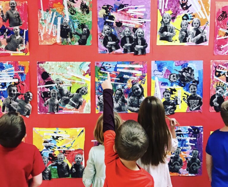 image of students looking at their artwork